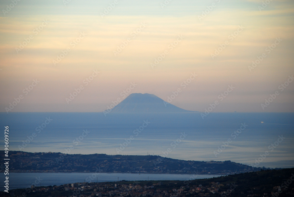 The island of Vulcano at sunset seen from mainland Italy The island of Vulcano at sunset seen from mainland Italy