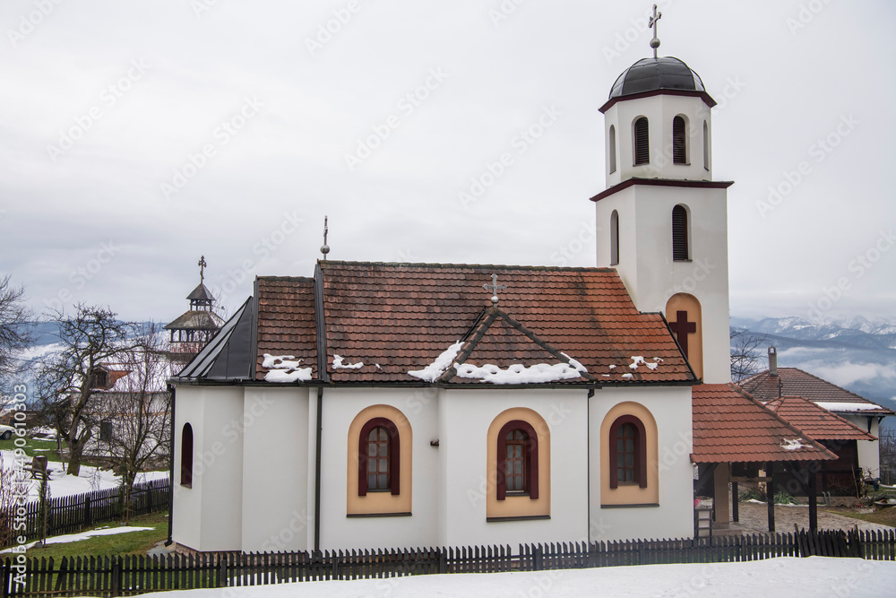 Entrance to Holy Trinity Monastery in mountain village on snowy winter day. Ljubovija, Serbia 05.02.2022