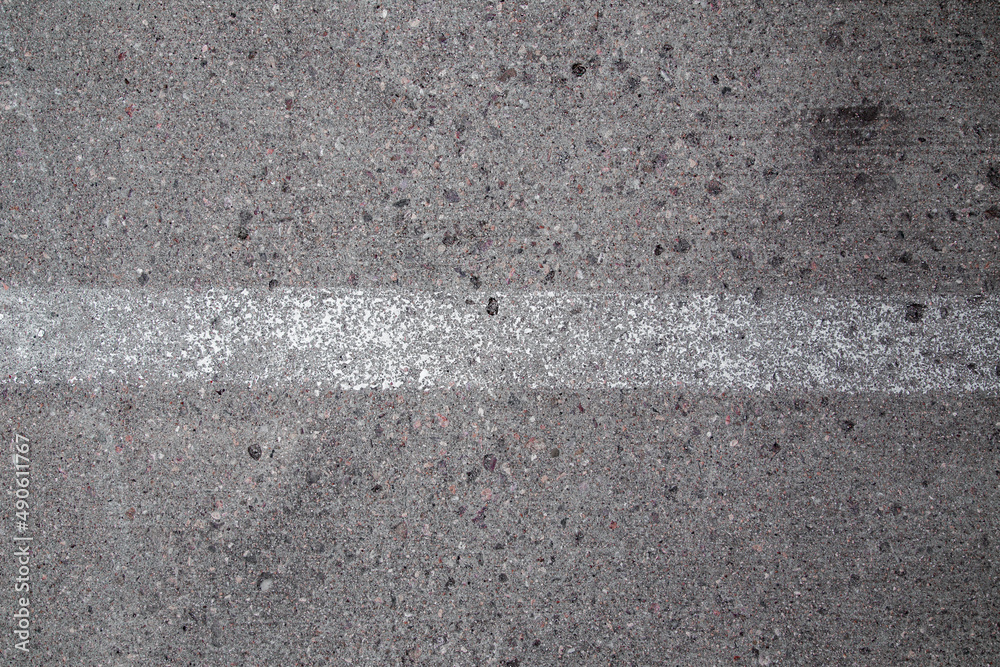 Fototapeta premium Real Rough Grey Grunge Concrete Asphalt Wall Backdrop Texture with Rocks and White Painted Stripe