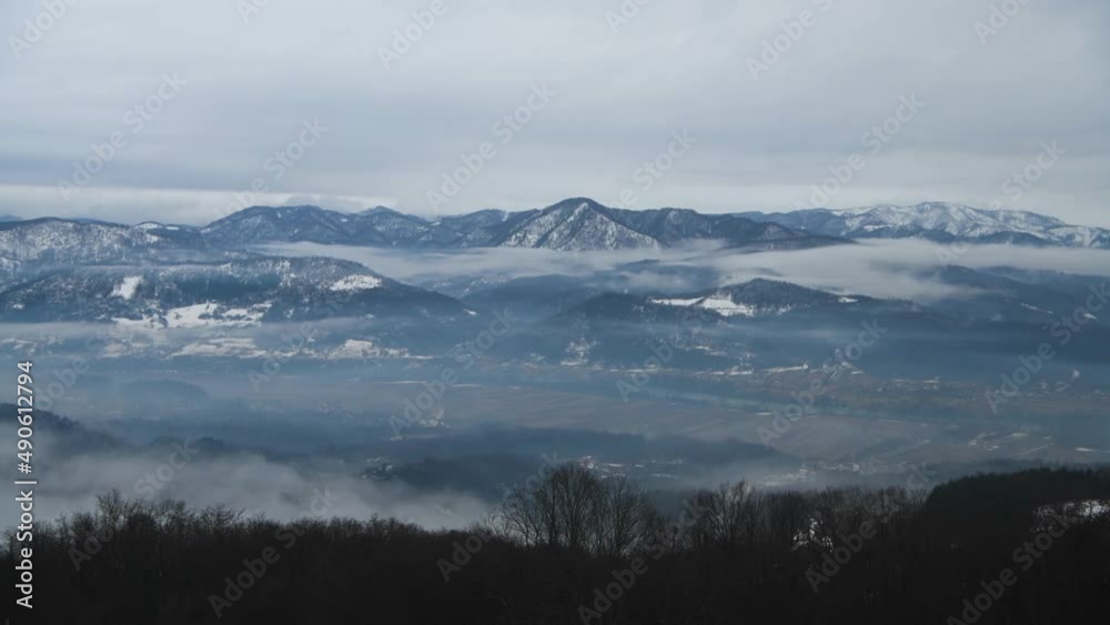 Beautiful scenic view of snow covered mountains and forest in Serbia. The oncoming fog is moving fast. Beautiful scenic view of snow covered mountains and forest in Serbia. The oncoming fog is moving fast.