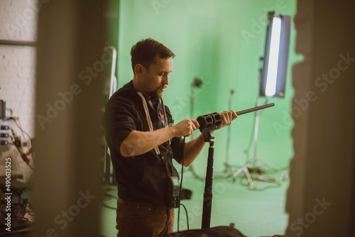 Sound engineer with a microphone on the set. A professional sound engineer at work on the filming of a movie, commercial or TV series.