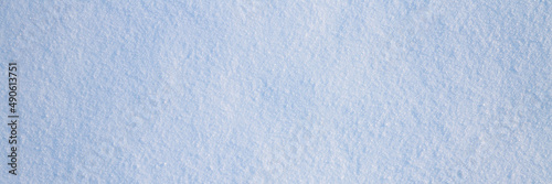 Natural snow texture. The surface of clean fresh snow. Snowy ground. Winter background with snow patterns. Wide panoramic texture for background and design. Perfect for Christmas and New Year design.