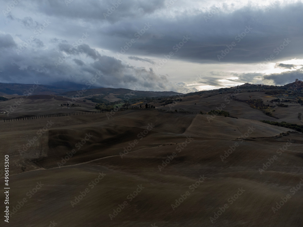 Aerial view on hills of Tuscany, Italy. Tuscan landscape with ploughed fields in autumn.