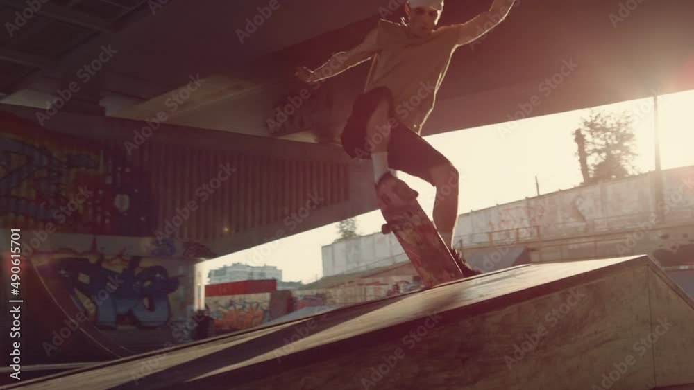 Young skater performing trick on skate board skate skate. Hipster skateboarding