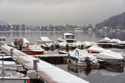 Small marina on Lake Lugano in winter with snow.  photo