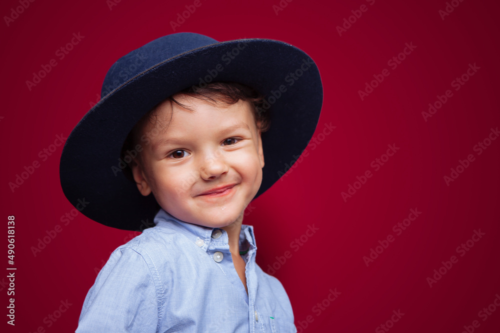 A child in a blue T shirt holds a poster with appeals for peace on a yellow background. no face, close-up A child in a blue T shirt holds a poster with appeals for peace on a yellow background. no face, close-up