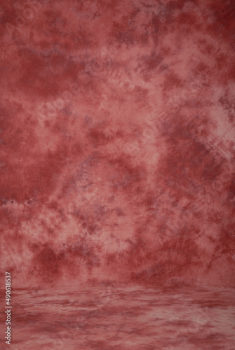 Dark red orange coral background, classic style paint stroke studio fabric background or backdrop.
