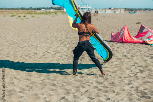 Woman preparing her kite for kitesurfing