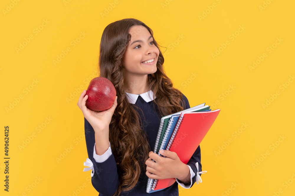 back to school. teen girl eat apple after study. healthy childhood. cheerful kid back to school. teen girl eat apple after study. healthy childhood. cheerful kid