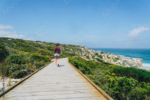 Woman walking on path at Seal bay on Kangaroo Island, South Australia