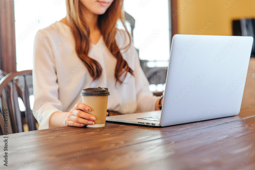 コーヒーを片手にPCを開く女性 office lady コーヒーを片手にPCを開く女性 office lady