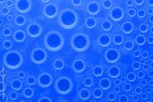 Water bubbles surface.wallpaper phone. background with drops in blue tones. Water bubbles and drops texture.blue circles pattern