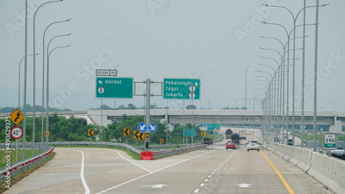 Trans Java toll road. There are signs for the city of Kendal, Jakarta, Pekalongan, Tegal photo