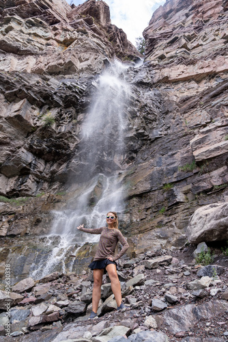 Woman hiker poses at Cascade Falls waterfall in Ouray Colorado photo