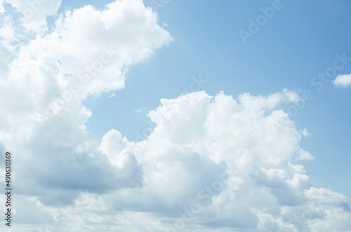 White air cumulus clouds in a blue sky. Summer background