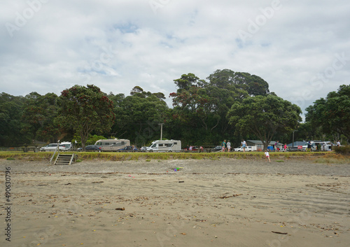 Tourist and local people playing at Bream Bay in Mangawhai, New Zealand on Sunday morning.