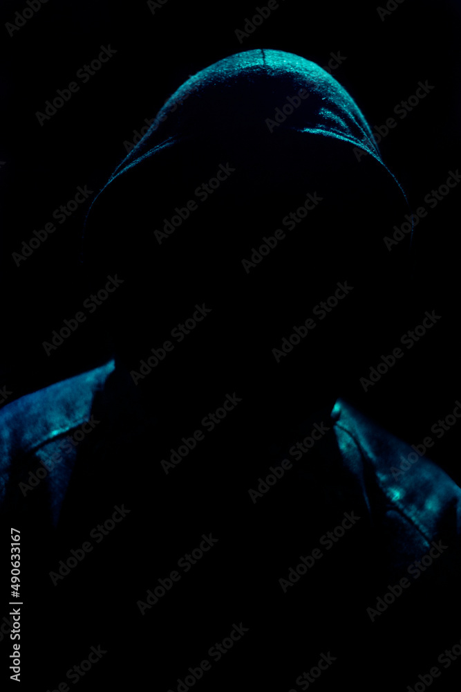 Dark and sinister silhouette on hooded figure on black background. Dark and sinister silhouette on hooded figure on black background.
