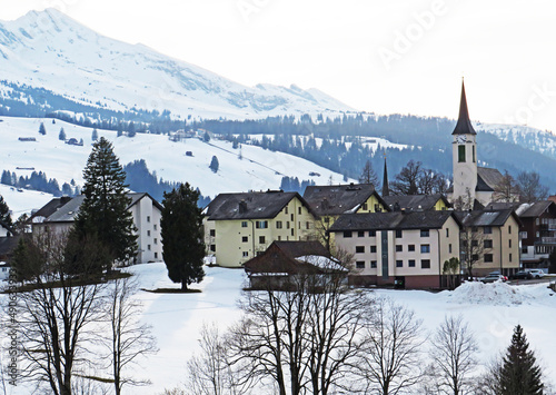 Alpine tourist, ski and agricultural village Wildhaus on the slopes of a Alpstein mountain range and over the Obertoggenburg valley - Canton of St. Gallen, Switzerland (Schweiz)