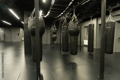 RUSSIA, MOSCOW - FEB 24, 2022: bag punching boxing training fist, from competition fitness in fight for bags heavy, knockout target. Martial circle dark, aggression