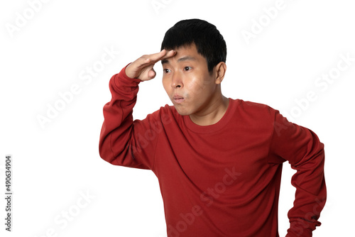 Portrait of young man holding hand at forehead look far away distance.