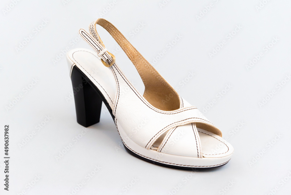 Fototapeta premium White vintage high-heeled sandals. isolated. Light gray background.