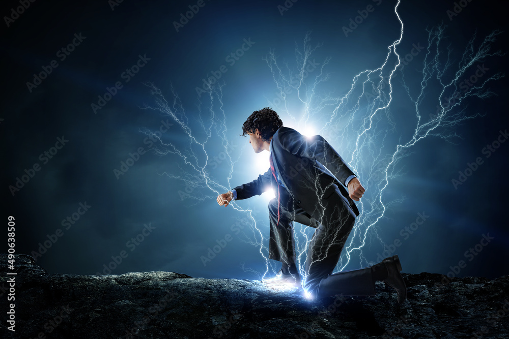 Determined businessman leaving fire trails on asphalt