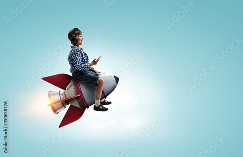 Kid wearing headphones on a rocket