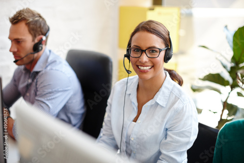 Shes got all the qualities of a great salesperson. Shot of customer service representatives taking calls in their office.