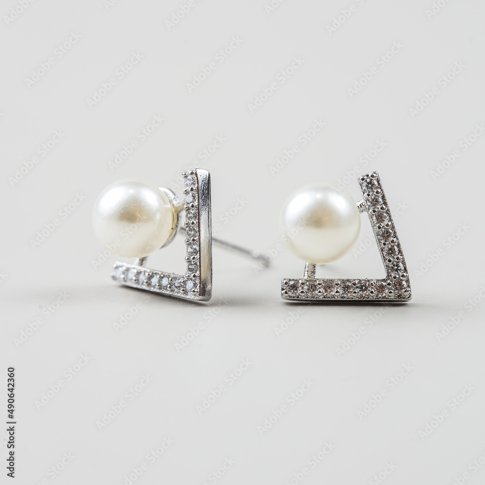 A beautiful Pearl Ear studs. Close-up of white pearl earrings.
A beautiful Pearl Ear studs. Close-up of white pearl earrings.