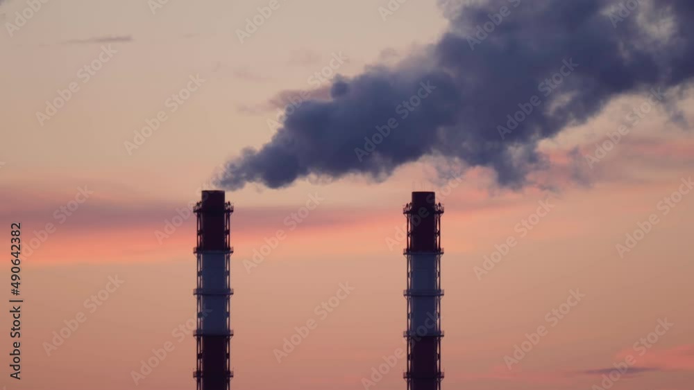 Factory pipes thermal power plants with thick white smoke from heat energy nuclear plant polluting environment. Selective focus Factory pipes thermal power plants with thick white smoke from heat energy nuclear plant polluting environment. Selective focus