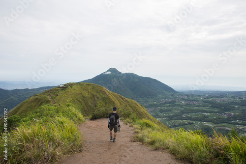 One backpacker man travel alone  with backpack in the mountains 