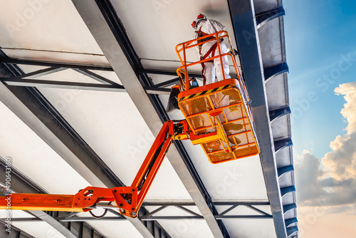 Civil engineer inspection under bridge construction by car lift at sydney city, australia