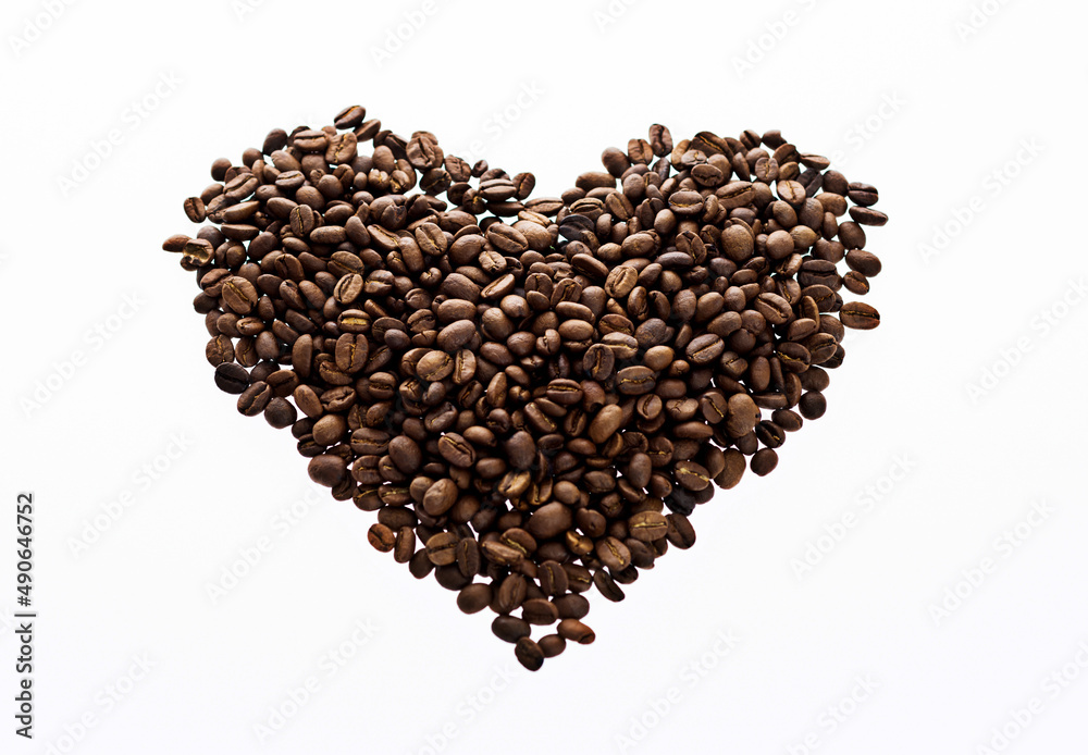 Coffee beans in heart shape against white background Coffee beans in heart shape against white background
