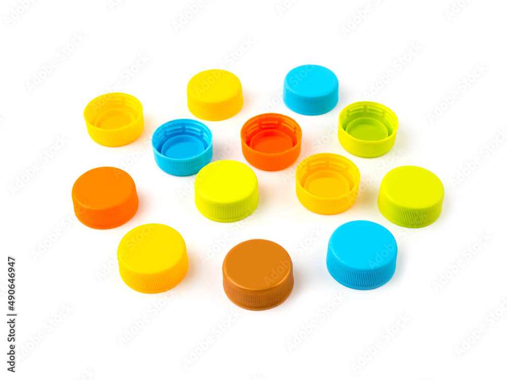 Colorful plastic bottle caps on white background. Colorful plastic bottle caps on white background.