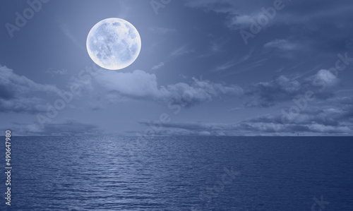 Moon rise in the clouds over the sea at night "Elements of this image furnished by NASA