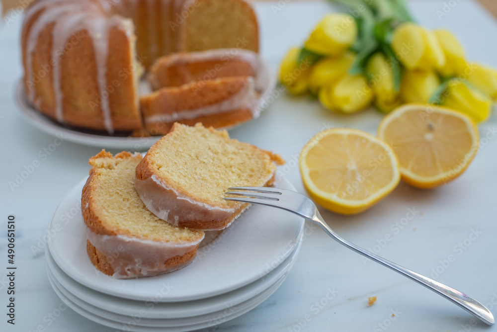 Traditional vanilla pound cake with lemon on a table Traditional vanilla pound cake with lemon on a table