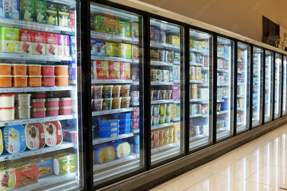 SELANGOR, MALAYSIA 28 FEB 2022 Huge glass fridge with various brands frozen food ice cream in