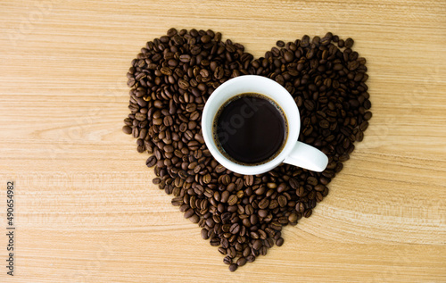Cup of coffee in heart shape of coffee seeds