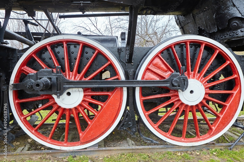 Wheels of an old railway train of the early 19th century in an open-air museum. Historical objects.