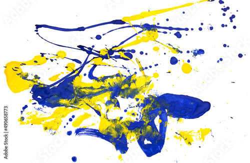 Drops of yellow and blue paint on a white paper background.