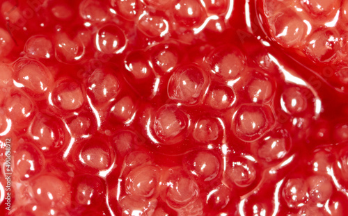 Red fish caviar as an abstract background.