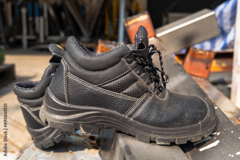 Wear safety shoes to ensure safety at work. construction workers wear ...