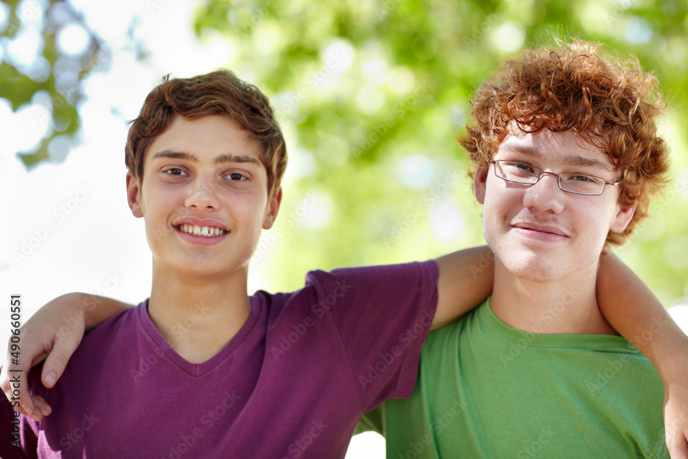 Two peas in a park. Portrait of two teenage boys hanging out at the park. Two peas in a park. Portrait of two teenage boys hanging out at the park.