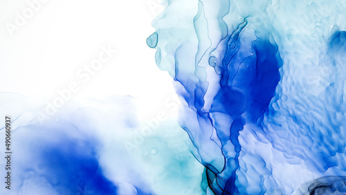 Translucent Alcohol ink on white backdrop. Modern background. Abstract smudges and stains made with turquoise and blue alcohol ink. Contemporary fluid art. Luxury pattern. Wrapping paper, wallpape