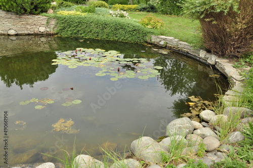 Garden pond. Pond in landscape design.