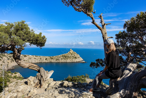 A girl on the background of a panorama of Cape Kapchik on the Galitsin trail. Black Sea Russia. 2021