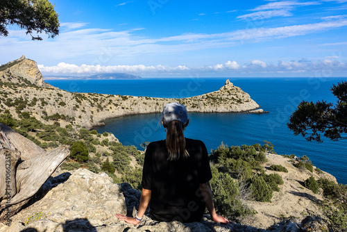 A girl on the background of a panorama of Cape Kapchik on the Galitsin trail. Black Sea Russia. 2021