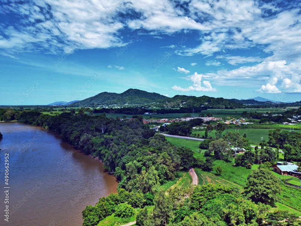 Aerial view of land river and mountain backdrop