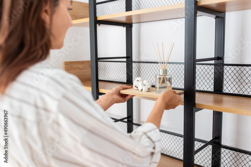Foto home improvement, decoration and people concept - close up of woman placing arom