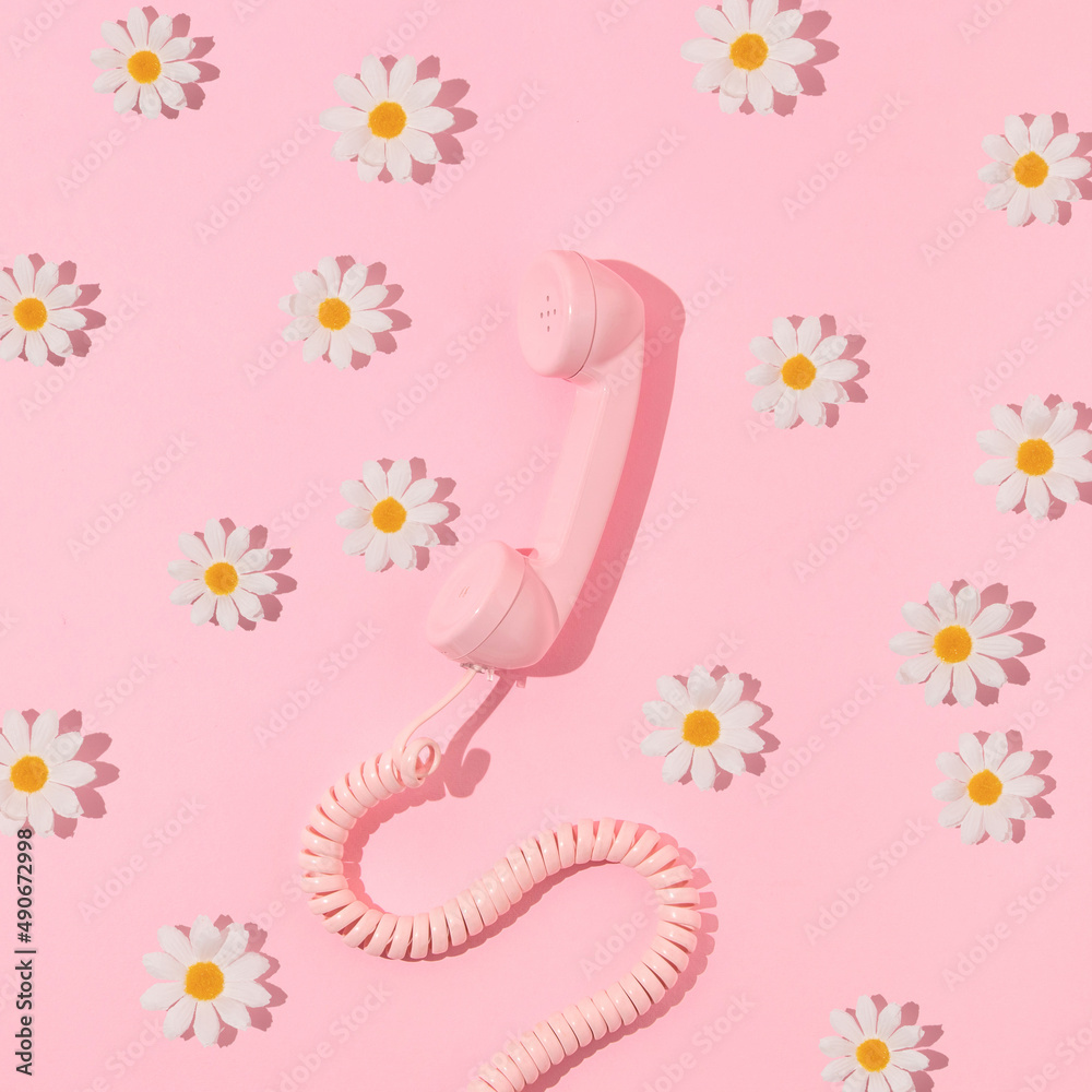 Spring creative layout with pink retro phone handset and white flowers on pastel pink. 80s or 90s retro fashion aesthetic telephone and flowers concept. Minimal romantic communication idea. - obrazy, fototapety, plakaty 